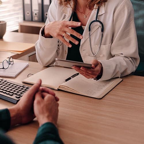 Healthcare professional talking with a patient.